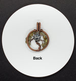 This Handmade Copper Tree Pendant is a beautifully crafted, nature-inspired piece that showcases the artisan’s skill in working with copper and natural stones. The pendant features a tree of life design, using heavy gauge copper to form the frame, while the leaves are made from Labradorite chips. A Larvikite Moon adds a celestial element, making this piece a stunning combination of nature and spirituality.