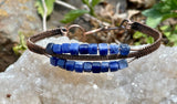 This bracelet features square-cut blue Sodalite beads, known for their rich, deep hues and natural patterns. The copper wirework creates a beautiful contract and enhances the bracelet's elegance while maintaining its rustic charm.