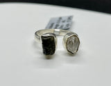 This captivating ring showcases the natural beauty of raw Quartz and raw Moldavite, set in sterling silver for a rustic yet elegant look. The adjustable band fits sizes 6 ½ and up, offering versatility and comfort. The clear, uncut Quartz radiates purity, while the rare, deep green Moldavite adds a touch of otherworldly mystique. Together, these stones are believed to enhance spiritual growth and energy. Perfect for those who appreciate raw, organic beauty, this ring is a unique and powerful statement piece
