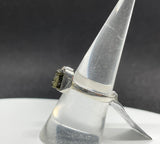 This captivating ring showcases the natural beauty of raw Quartz and raw Moldavite, set in sterling silver for a rustic yet elegant look. The adjustable band fits sizes 6 ½ and up, offering versatility and comfort. The clear, uncut Quartz radiates purity, while the rare, deep green Moldavite adds a touch of otherworldly mystique. Together, these stones are believed to enhance spiritual growth and energy. Perfect for those who appreciate raw, organic beauty, this ring is a unique and powerful statement piece