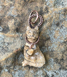 A carved picture jasper cat pendant wrapped in copper wire — earthy, graceful, and full of quiet personality. A perfect piece for cat lovers who see beauty in nature’s details.