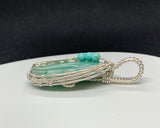 A beautiful Quartz pendant with silicated Chrysocolla inclusions and Turquoise accent beads in wire wrapped Sterling (.925) and Fine (.999) Silver.