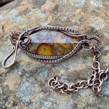 Elevate your style with this handcrafted adjustable bracelet featuring stunning bamboo jasper stones, intricately wire-wrapped in warm copper. The earthy tones of the jasper harmonize beautifully with the rustic shine of copper, making this piece perfect for nature lovers and those seeking a unique accessory. Its adjustable design ensures a comfortable fit for any wrist size, blending elegance with versatility.