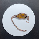 Elevate your style with this handcrafted adjustable bracelet featuring stunning bamboo jasper stones, intricately wire-wrapped in warm copper. The earthy tones of the jasper harmonize beautifully with the rustic shine of copper, making this piece perfect for nature lovers and those seeking a unique accessory. Its adjustable design ensures a comfortable fit for any wrist size, blending elegance with versatility.
