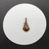 Embrace the spirit of fall with this charming swirling Goldstone pumpkin pendant, beautifully wrapped in warm copper. The rich, shimmering tones of the Goldstone capture the essence of autumn, while a delicate glass leaf accent adds a playful touch. This unique pendant is perfect for celebrating the season, making it an ideal accessory for fall festivities or a thoughtful gift for nature lovers. Add a touch of seasonal elegance to your collection with this delightful piece!