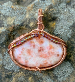 Sparkling Sunstone Pendant in Wire Wrapped Copper with glass bead accents.