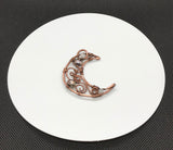 This Copper Moon Pendant is an enchanting piece accented with delicate Freshwater Pearls and Moonstones. The combination of these elements creates a celestial and feminine aesthetic that evokes a sense of mystery and beauty. The warm tones of the copper contrast beautifully with the iridescence of the Moonstone and the soft sheen of the pearls, making this pendant a striking accessory for any occasion.