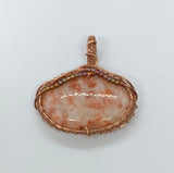 Sparkling Sunstone Pendant in Wire Wrapped Copper with glass bead accents.