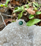 This stunning adjustable ring features a mesmerizing Green Goldstone, wire wrapped in Argentium Silver. The rich green tones of the Goldstone sparkle with flecks of silver, creating a captivating effect that catches the light beautifully. The ring's adjustable design ensures a perfect fit for various finger sizes, making it a versatile and elegant addition to any jewelry collection. The combination of the shimmering Green Goldstone and the sleek Argentium Silver creates an eye-catching piece.