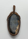Mystery Blue Stone Pendant in handwoven Copper.