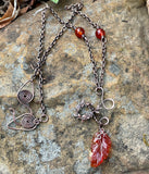A carnelian leaf pendant rests on copper, accented with carnelian beads and delicate copper leaves — this necklace is a piece that feels alive, like autumn caught in motion.