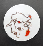 A carnelian leaf pendant rests on copper, accented with carnelian beads and delicate copper leaves — this necklace is a piece that feels alive, like autumn caught in motion.
