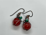These charming mini pumpkin earrings feature beautifully crackled Agate beads in warm, autumnal tones, paired with copper accents to create a delightful pumpkin design. Topped with delicate green glass leaves, these earrings capture the essence of fall in a playful and elegant way. Finished with hypoallergenic niobium ear wires for comfort, these earrings are perfect for the season and ideal for anyone who loves whimsical, handcrafted jewelry.