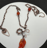 A carnelian leaf pendant rests on copper, accented with carnelian beads and delicate copper leaves — this necklace is a piece that feels alive, like autumn caught in motion.