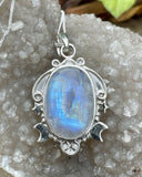 This enchanting pendant showcases a mesmerizing rainbow moonstone with an iridescent glow, set in a beautifully detailed sterling silver setting adorned with celestial stars and a crescent moon. Suspended on a 20" sterling silver chain, this piece captures the magic of the night sky, making it a perfect gift for dreamers and stargazers.