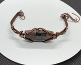 Hand woven Copper bracelet with Candlelite and Dumortierite bead accents.