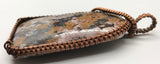 This Bold Flower Jasper Pendant in Copper features a striking and vibrant flower jasper stone set within a beautifully crafted copper frame. Known for its rich colors and intricate patterns, the flower jasper provides a dramatic focal point, while the copper setting enhances the pendant's natural beauty with a touch of artisanal elegance. This pendant is a statement piece that combines bold design with handcrafted quality.