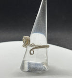 This stunning adjustable ring showcases a mesmerizing Australian Opal with a lovely purple flash, wire wrapped in Argentium Silver. Adjustable to fit a range of sizes, this ring combines elegance with practicality, making it both a statement piece and a comfortable, versatile accessory. The Argentium Silver ensures a bright, tarnish-resistant finish, perfect for showcasing the Opal's magical colors. A true one-of-a-kind treasure!