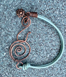 This vibrant turquoise-colored leather bracelet adds a pop of color to your accessory collection. Crafted with care, it features unique handmade hammered copper clasps that provide both durability and artistic flair. A charming flower dangle accentuates the design, adding a playful touch. This bracelet is not only stylish but also comfortable, making it a perfect choice for everyday wear or special occasions. Embrace the beauty of handcrafted jewelry with this delightful piece!