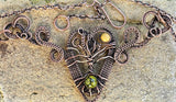 This Wire Wrapped Copper Necklace is a stunning display of artisan craftsmanship, combining various natural elements with intricate copper wire weaving. Featuring a woven copper heart, a symbolic copper Tree of Life, a warm Mookaite Jasper Sun, and a striking Dragon’s Vein Agate, this necklace is a work of art that carries deep symbolism and timeless beauty. It is the perfect statement piece for those who appreciate the elegance of handcrafted jewelry and the power of natural stones.