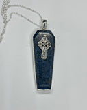 This captivating necklace features a deep blue Dumortierite stone, expertly shaped into a coffin design and set in sterling silver. The pendant is adorned with an intricate Celtic cross, symbolizing unity and eternal life. The contrast between the rich tones of the Dumortierite and the sleek sterling silver adds depth and elegance, making this piece perfect for those who appreciate symbolic, gothic-inspired jewelry with a touch of timeless craftsmanship.