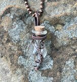 Glass Bottle Keepsake Necklace in Copper. Removable cork allows you to fill this wire wrapped bottle with any small keepsakes, a special note, ashes, anything meaningful to you or whomever you give it to