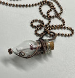 Glass Bottle Keepsake Necklace in Copper. Removable cork allows you to fill this wire wrapped bottle with any small keepsakes, a special note, ashes, anything meaningful to you or whomever you give it to