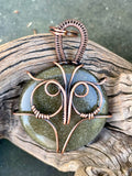 This enchanting pendant features a Copper owl set over Golden Sheen Obsidian, known for its mysterious dark surface with shimmering gold undertones. Hand-wrapped in warm copper wire, the design highlights the owl’s wise, mystical presence and the stone’s natural glow. A perfect piece for nature lovers, night owls, and anyone who enjoys a touch of magic in their jewelry.