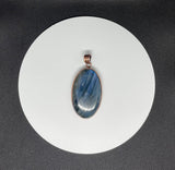 This bold pendant showcases a striking blue labradorite with vibrant flashes of color that dance in the light. Set in copper, the design enhances the stone’s natural iridescence and mystical appeal. A powerful statement piece, perfect for those drawn to the magic of labradorite.