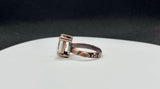 This enchanting ring features a large, faceted clear quartz gemstone that sparkles with natural brilliance. Set in warm copper, the band is adorned with delicate leaf and flower motifs, adding a touch of botanical elegance to the bold, eye-catching design.