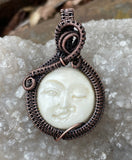 Cheeky Winking Moon Carved Bone Pendant in Copper. 