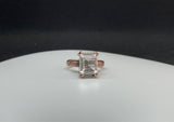 This enchanting ring features a large, faceted clear quartz gemstone that sparkles with natural brilliance. Set in warm copper, the band is adorned with delicate leaf and flower motifs, adding a touch of botanical elegance to the bold, eye-catching design.