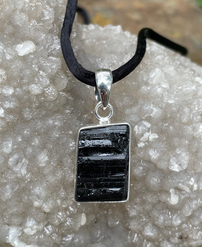Raw Black Tourmaline Pendant in Sterling Silver on Black Satin Cord (18") with Sterling Silver Clasps.
