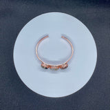 This celestial-inspired copper bangle features two Laguna Lace Agate crescent moons and one striking full moon centerpiece. The natural swirls and vibrant banding of the agate stones create a beautiful contrast against the copper setting. A symbolic and one-of-a-kind bracelet that captures the magic of moon phases.