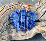 Carved Sodalite Butterfly Pendant set in Copper. A symbol of transformation and inner peace, this piece brings both beauty and meaning to your jewelry collection.