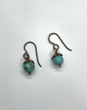 These lovely earrings feature vibrant turquoise beads topped with warm copper bead caps, creating a beautiful contrast of color and texture. Suspended from hypoallergenic niobium ear wires, they offer both comfort and style. Lightweight and versatile, they’re perfect for everyday wear or adding a pop of natural color to any look.