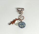 Hammered Copper Ear Cuff with 3 interchangeable celestial dangles.&nbsp; Comes with Goldstone stars dangle, an iridescent Glass full moon dangle&nbsp; and a Mother of Pearl half moon dangle. Wear one, none or all three, it's like 4 earrings in one! This was designed to be worn on the left ear. 