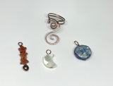 Hammered Copper Ear Cuff with 3 interchangeable celestial dangles.&nbsp; Comes with Goldstone stars dangle, an iridescent Glass full moon dangle&nbsp; and a Mother of Pearl half moon dangle. Wear one, none or all three, it's like 4 earrings in one! This was designed to be worn on the left ear. 