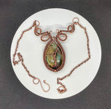 This enchanting necklace features a luminous Labradorite cabochon, cradled in an intricately handwoven copper frame with a Tree of Life design on the front. The flowing branches and detailed wirework highlight the stone’s mystical flashes of blue, green and yellow, symbolizing growth, grounding, and transformation. A meaningful and beautifully crafted piece, perfect for those who find magic in nature and strength in symbolism.