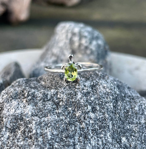 This Sterling Silver Peridot Turtle Ring is ideal for individuals who appreciate unique, handcrafted jewelry with natural gemstones. It appeals to those who enjoy meaningful accessories with elegant designs. This ring is perfect for anyone seeking a distinctive piece that adds a touch of sophistication and symbolism to their jewelry collection.