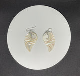 These Sterling Silver Carved Nautilus Shell "Angel Wing" Earrings are a captivating pair of earrings that combine the natural beauty of nautilus shells with the elegance of sterling silver. The earrings feature intricately carved nautilus shells, reminiscent of angel wings, set in high-quality sterling silver. These earrings evoke a sense of grace, nature, and artistry, making them a unique and elegant accessory.