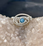 This elegant ring features a stunning Aquamarine gemstone bead set in high-quality Argentium silver, known for its bright finish and tarnish resistance. The serene blue hues of the Aquamarine evoke the calming essence of the sea, making this piece both soothing and sophisticated. Designed in a size 8, this ring is perfect for those seeking a blend of natural beauty and modern elegance. Ideal for everyday wear or special occasions, it adds a refreshing touch to any jewelry collection.