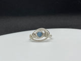 This elegant ring features a stunning Aquamarine gemstone bead set in high-quality Argentium silver, known for its bright finish and tarnish resistance. The serene blue hues of the Aquamarine evoke the calming essence of the sea, making this piece both soothing and sophisticated. Designed in a size 8, this ring is perfect for those seeking a blend of natural beauty and modern elegance. Ideal for everyday wear or special occasions, it adds a refreshing touch to any jewelry collection.