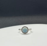 This Sterling Silver Blue Chalcedony Ring is an elegant piece of jewelry that highlights the calming beauty of blue chalcedony, set in a sleek sterling silver band. This ring combines the soothing, tranquil color of the gemstone with the timeless appeal of sterling silver, making it a versatile and stylish accessory.