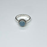 This Sterling Silver Blue Chalcedony Ring is an elegant piece of jewelry that highlights the calming beauty of blue chalcedony, set in a sleek sterling silver band. This ring combines the soothing, tranquil color of the gemstone with the timeless appeal of sterling silver, making it a versatile and stylish accessory.