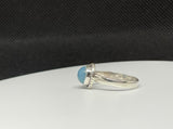 This Sterling Silver Blue Chalcedony Ring is an elegant piece of jewelry that highlights the calming beauty of blue chalcedony, set in a sleek sterling silver band. This ring combines the soothing, tranquil color of the gemstone with the timeless appeal of sterling silver, making it a versatile and stylish accessory.