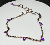 This charming adjustable ankle bracelet combines the warm glow of copper with the vibrant hues of purple Czech glass beads. The design features a delicate balance of color and texture, with the copper providing a sturdy yet flexible base and the Czech glass beads adding a touch of sparkle. The adjustable feature ensures a perfect fit for any ankle, making it a versatile and stylish accessory.