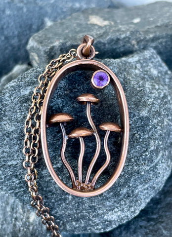 This Whimsical Copper Mushroom Necklace with Faceted Amethyst Accent is a delightful accessory that combines playful design with elegant gemstone accents. Perfect for adding a touch of whimsy to your outfit, this necklace makes a unique gift for someone special or a charming addition to your own jewelry collection.