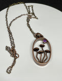 This Whimsical Copper Mushroom Necklace with Faceted Amethyst Accent is a delightful accessory that combines playful design with elegant gemstone accents. Perfect for adding a touch of whimsy to your outfit, this necklace makes a unique gift for someone special or a charming addition to your own jewelry collection.