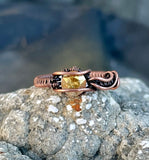 This eye-catching ring features a radiant sunshine-colored crystal, beautifully set in handwoven copper wire. The warm copper tones perfectly complement the crystal's brilliant metallic shimmer, creating a striking and bold design. Ideal for adding a touch of sparkle and warmth to any outfit, this ring is a unique piece for those who love vibrant colors and artisanal craftsmanship.